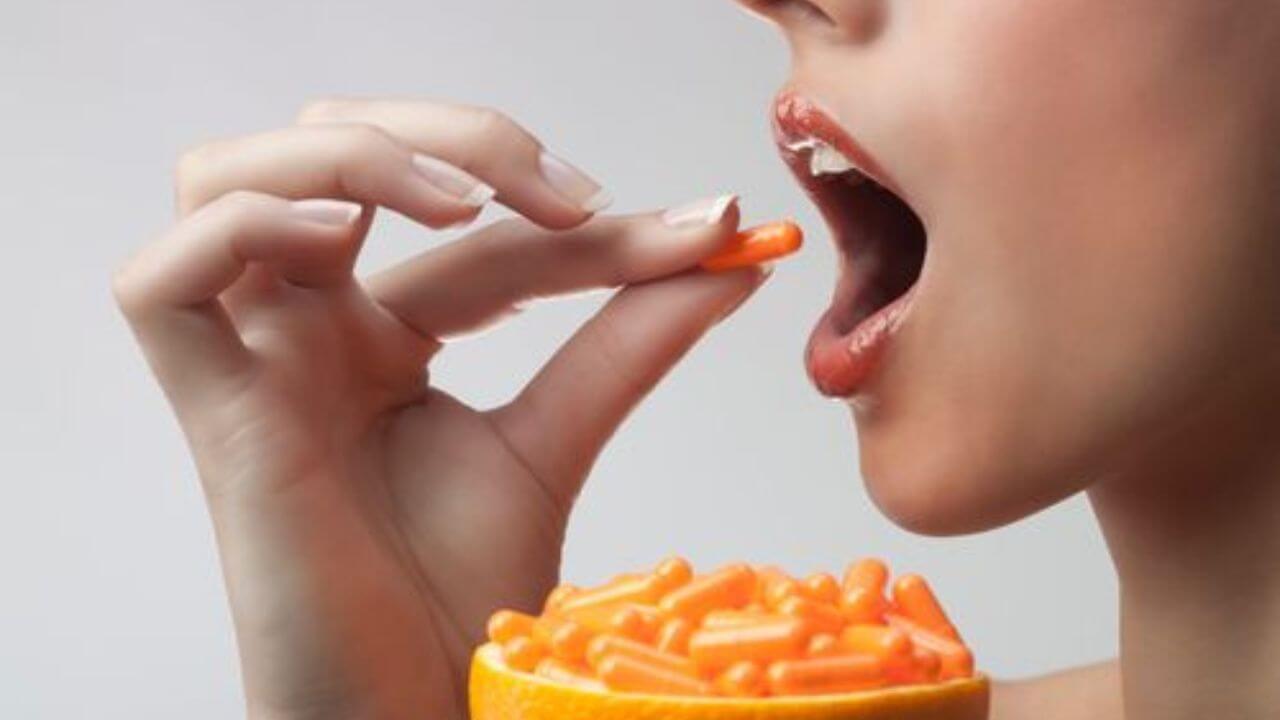 Image of young womwn eating a Vitamin C capsule.What Are Vitamin C Supplements Good For?
